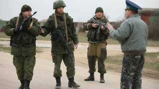 Crimean crisis: Warning shots fired by Russian troops as Ukrainian troops march towards Belbek air base carrying old Soviet Communist regiment flag