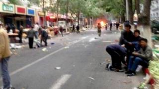 Bombs thrown from car in crowded Chinese market, killing at least 31 and injuring scores more