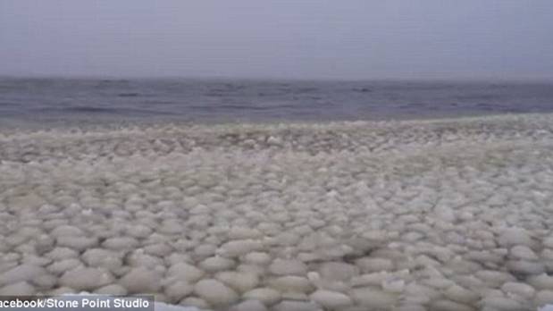 Thousands of mysterious snowballs wash up in waves on a Maine lake