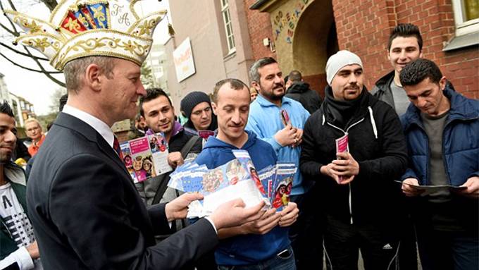 Cologne carnival organisers hand out leaflets telling migrants not to rape women or urinate in public in the wake of New Year sex attacks