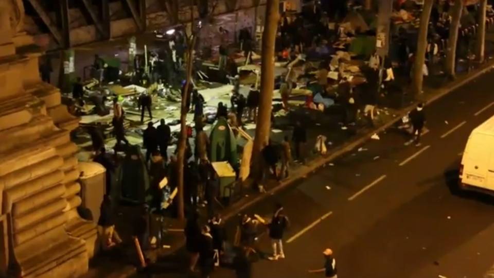 Hundreds of migrants with metal bars, planks of wood trash historic Paris train station